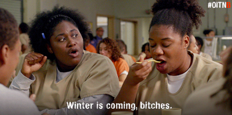 Image of a still from Orange is the New Black depicting Tasha and Cindy sitting in a prison canteen with caption "winter is coming, bitches"