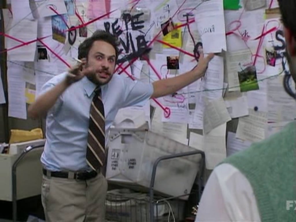 Image of Charlie Day from It's Always Sunny in Philadelphia looking crazed in front of a conspiracy wall covered in paper and red lines. 