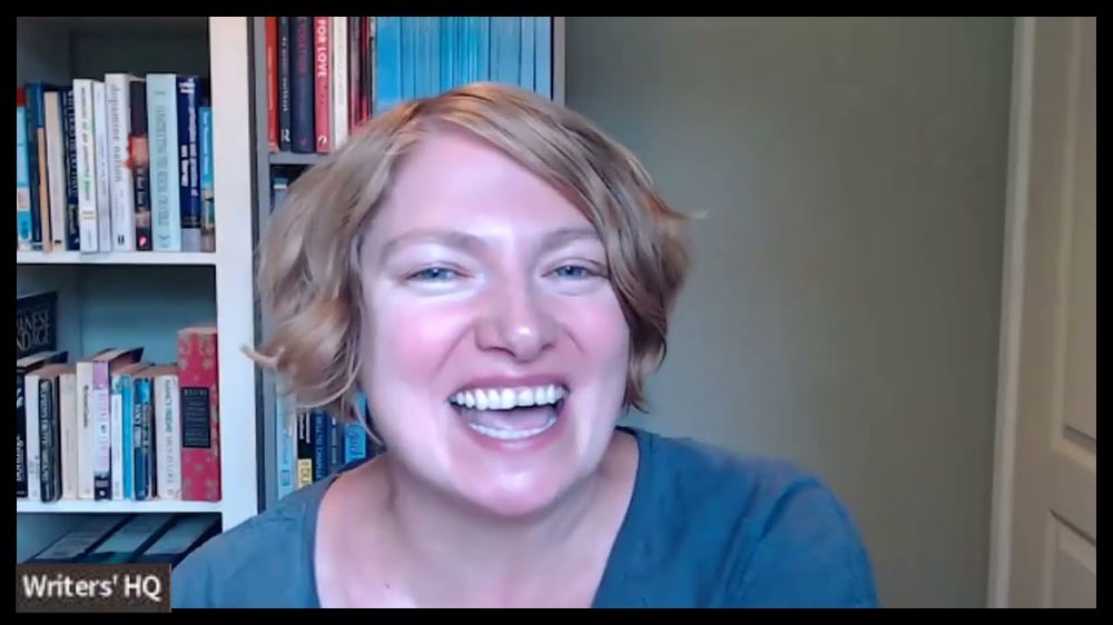 A thumbnail image from the Nothing Breaks Like A Heart workshop showing Tabitha Bast - a middle age woman with short blonde hair - smiling and sitting in front of a bookcase.